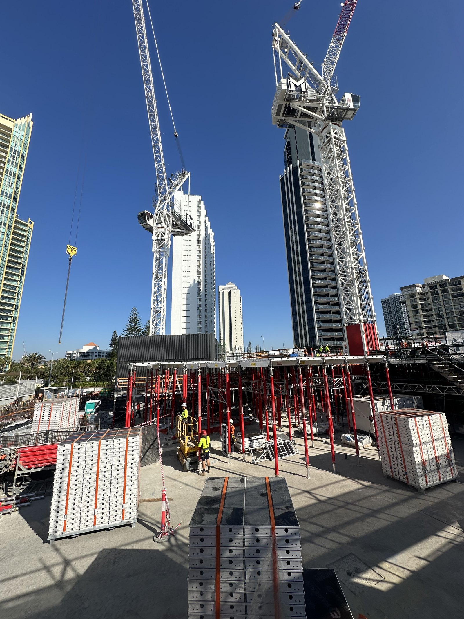 Marlu Formwork crew and formwork panels on a high-rise construction site with tower cranes